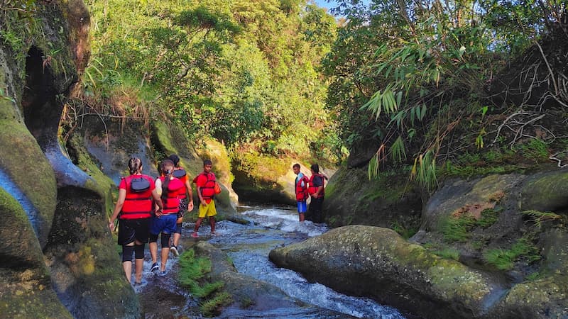 River canyoning at Mawlyngbna: the route follows the stream through a narrow rock gorge, roughly two hours with a local guide