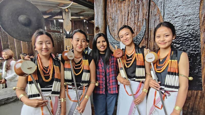 Female traveller with Naga women in traditional attire